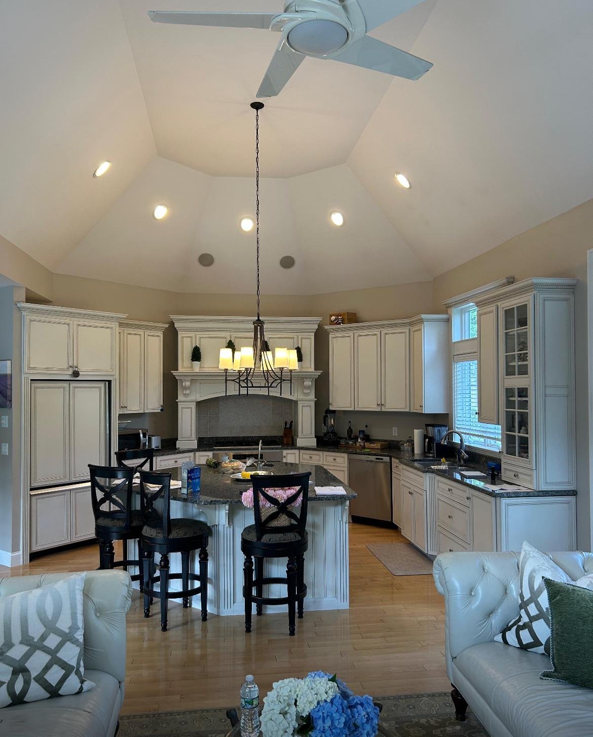 The original dated kitchen before the renovation, glazed cabinets and dark granite