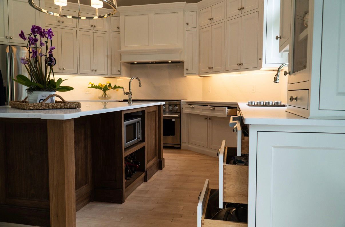 Finished kitchen with white inset cabinetry and walnut island, wide view