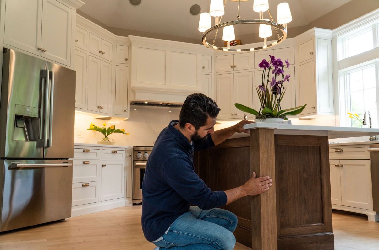 Craftsman fitting the walnut island during the install