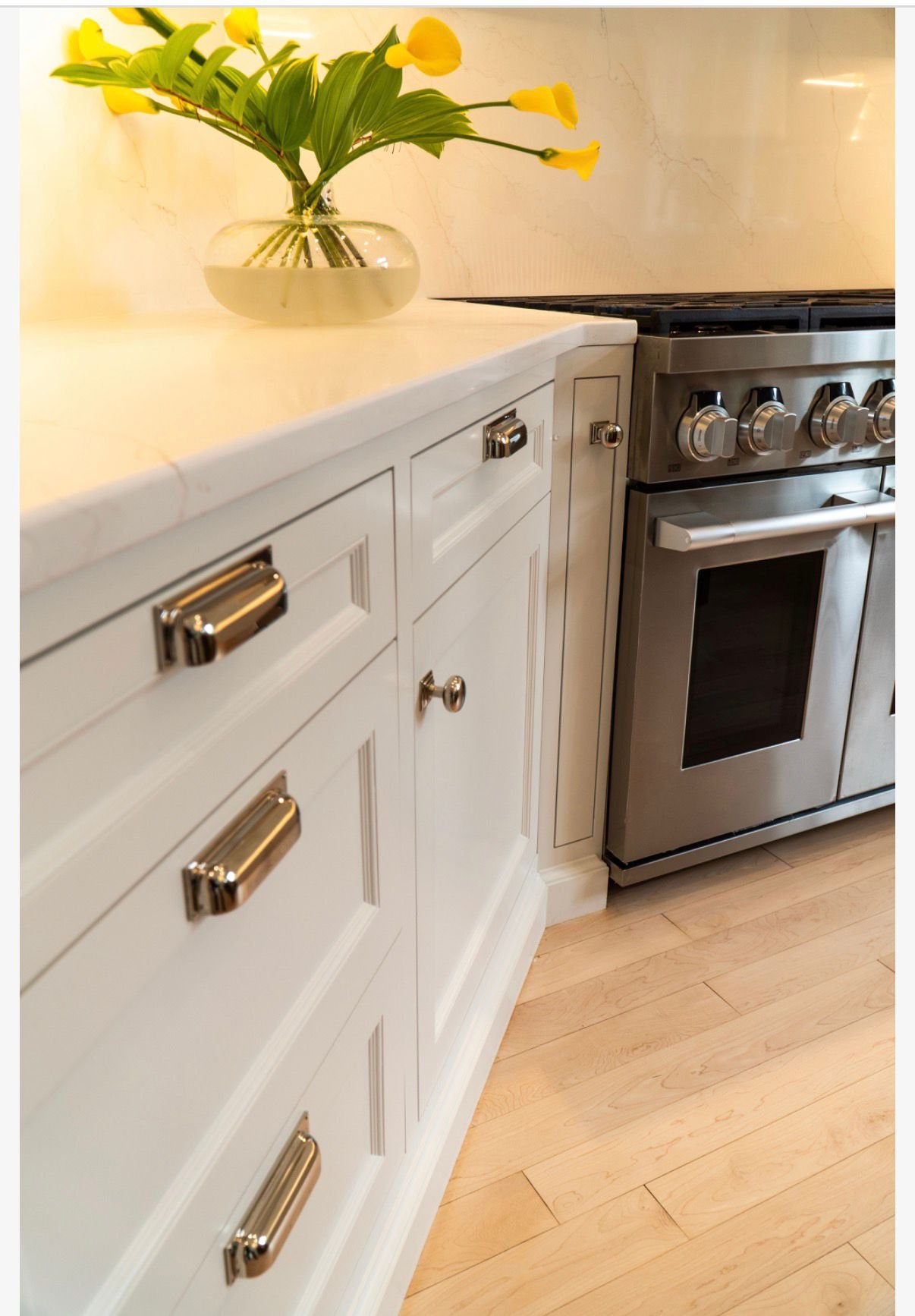 Brass hardware on white painted drawers