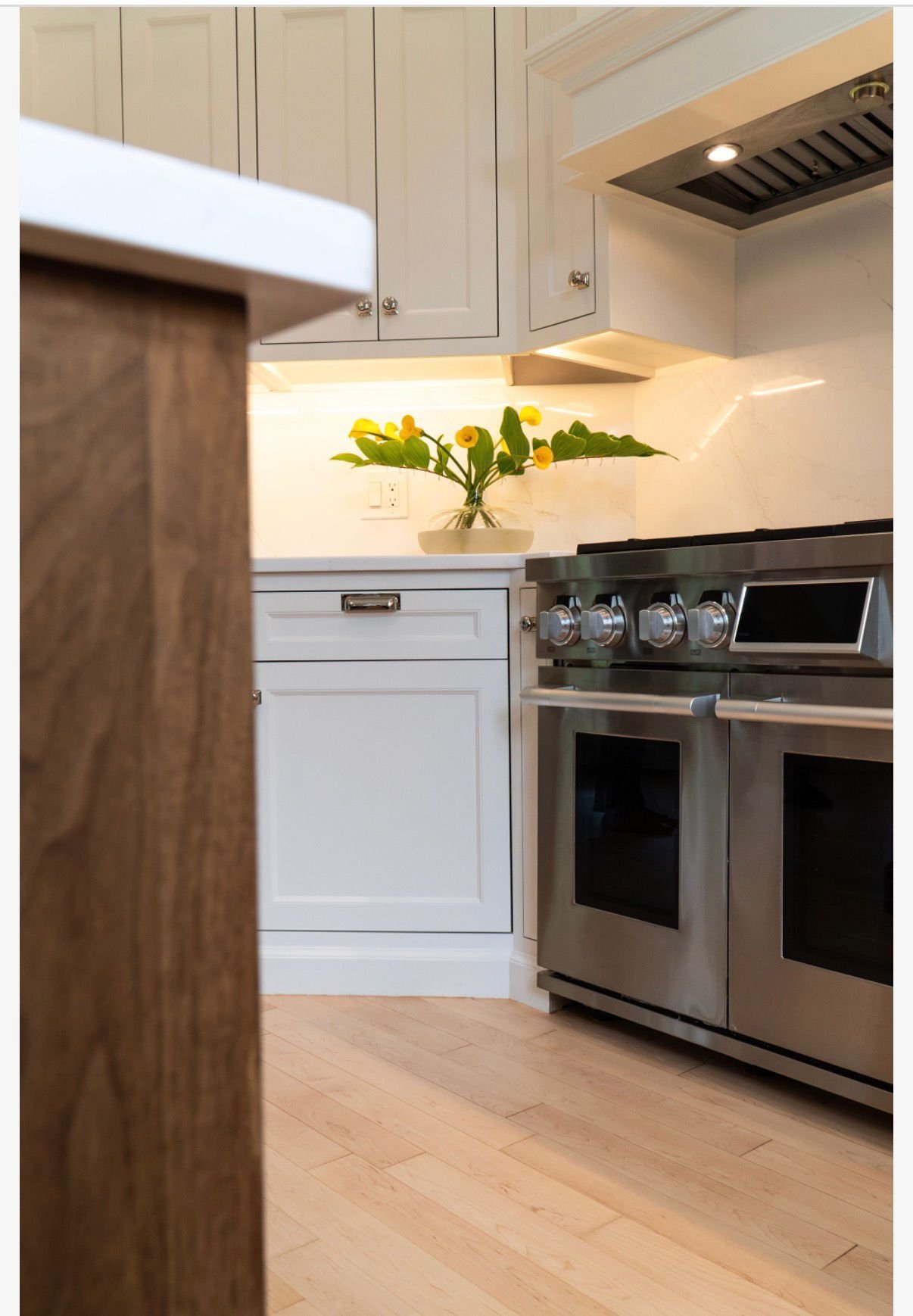 Solid walnut island and cabinetry against marble counters